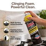 A hand sprays Bull Shot All-Purpose cleaner foam onto a greasy kitchen wall above the stove. Text highlights its streak-free clean, multi-surface grime emulsifying power, foaming action, and easy shake, point & spray use.