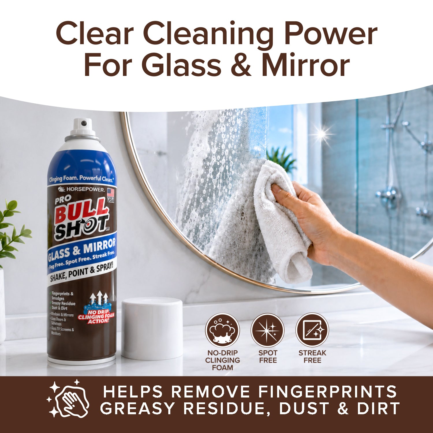 A hand wipes a bathroom mirror with a cloth while holding Bull Shot Glass & Mirror. Text highlights its streak-free, no-drip foam formula that removes fingerprints and leaves glass with a spotless shine.